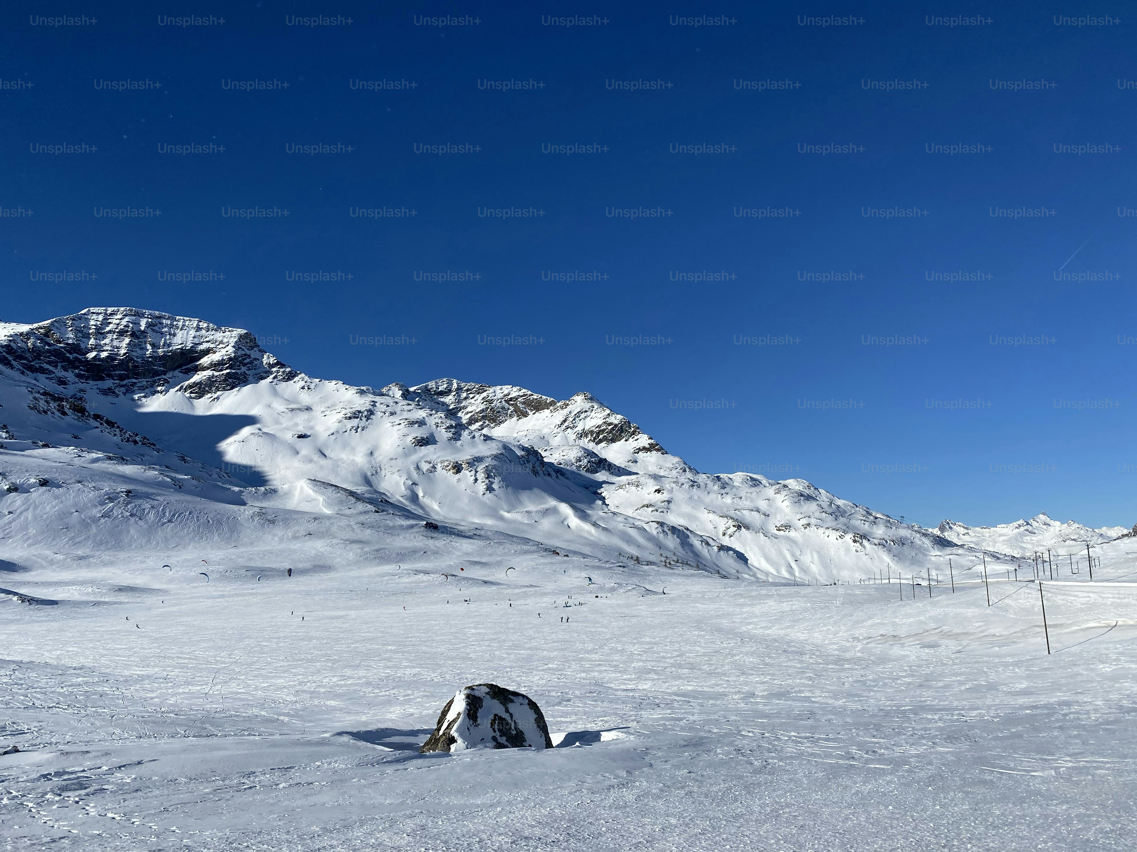 a man riding skis down a snow covered slope