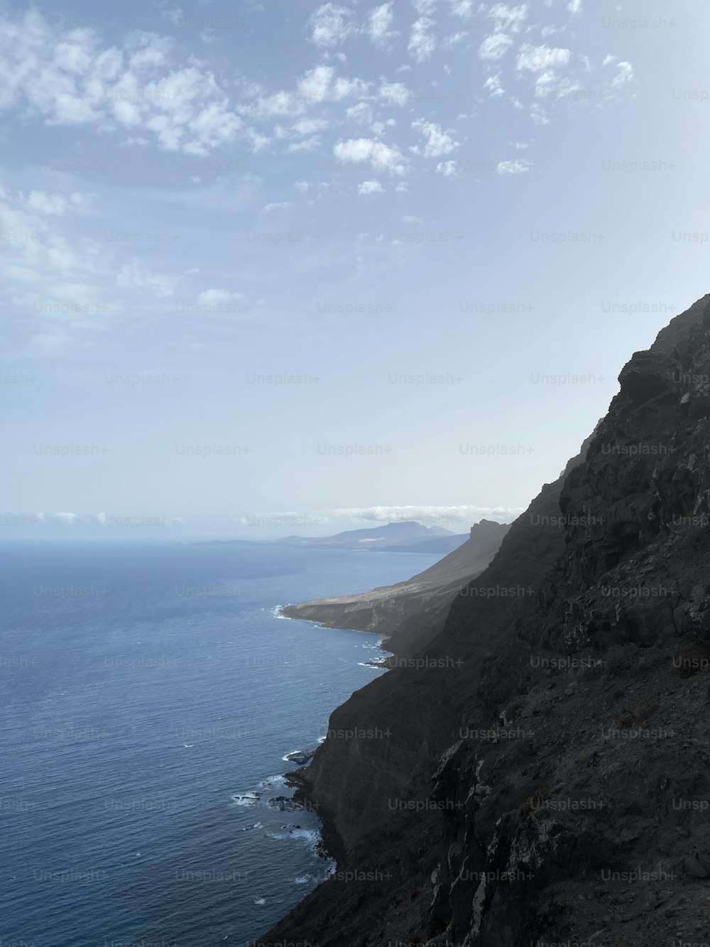 a view of the ocean from the top of a hill