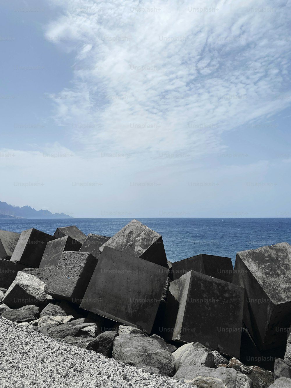 a pile of rocks sitting on top of a beach