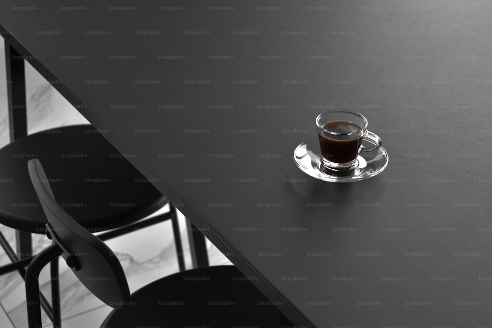 a cup of coffee sitting on top of a black table