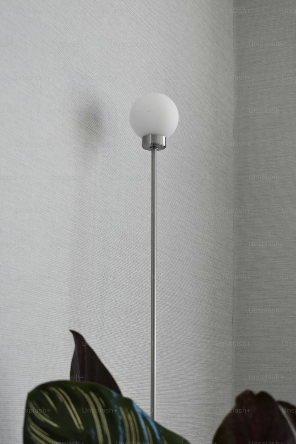 a lamp that is next to a plant