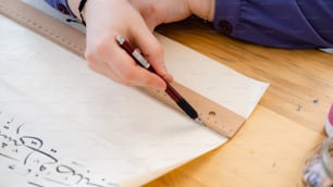 a person with a pen and paper on a table