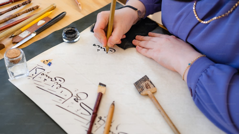 a woman is writing on a piece of paper