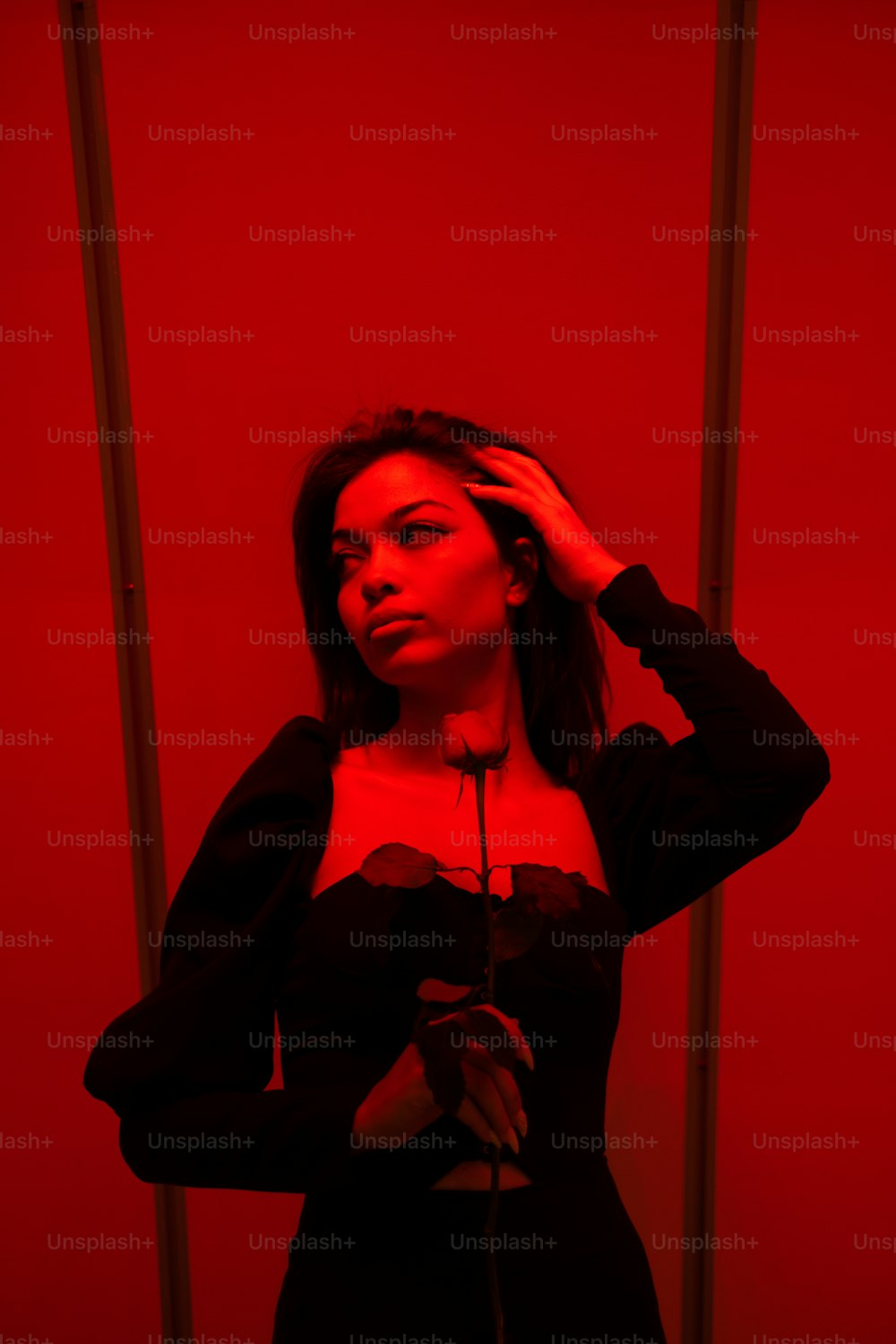 a woman standing in front of a red wall