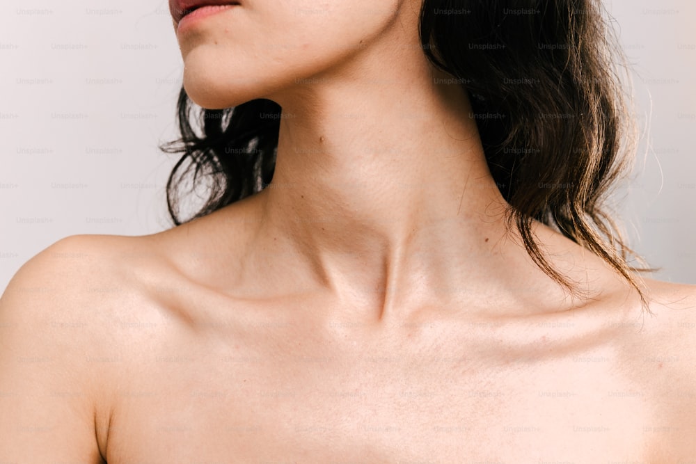 a close up of a woman with no shirt on