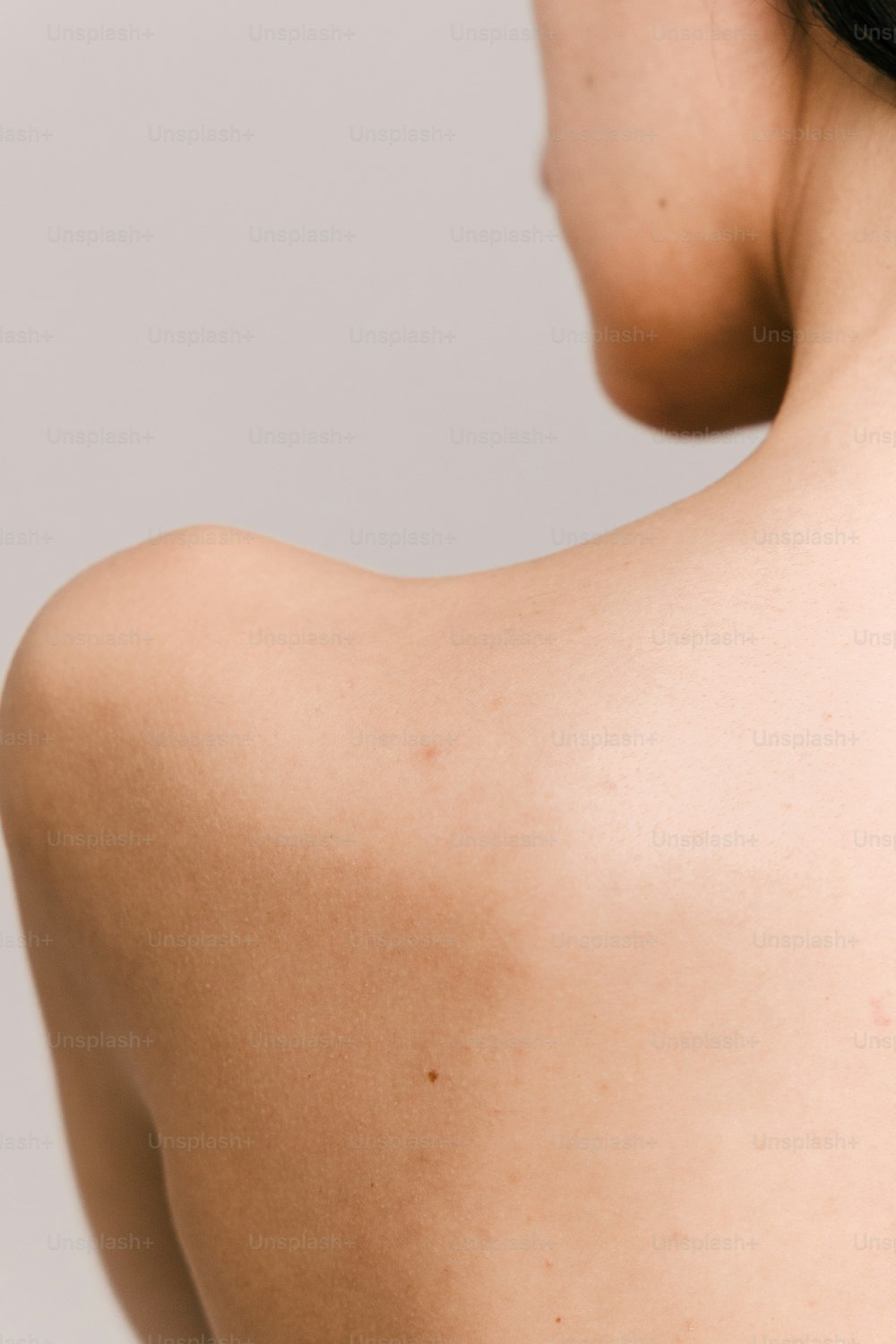 a close up of a woman's back and shoulder