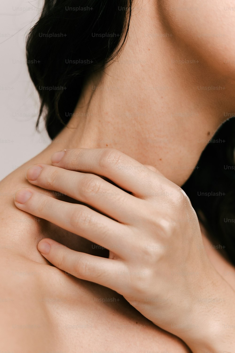 a woman with her hand on her neck