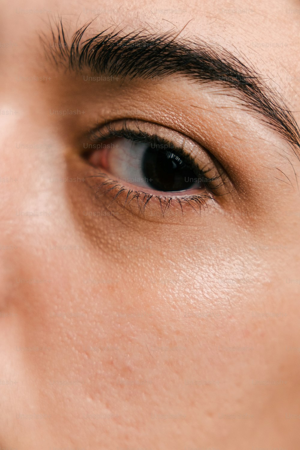 a close up of a person's eye with a cell phone in the background