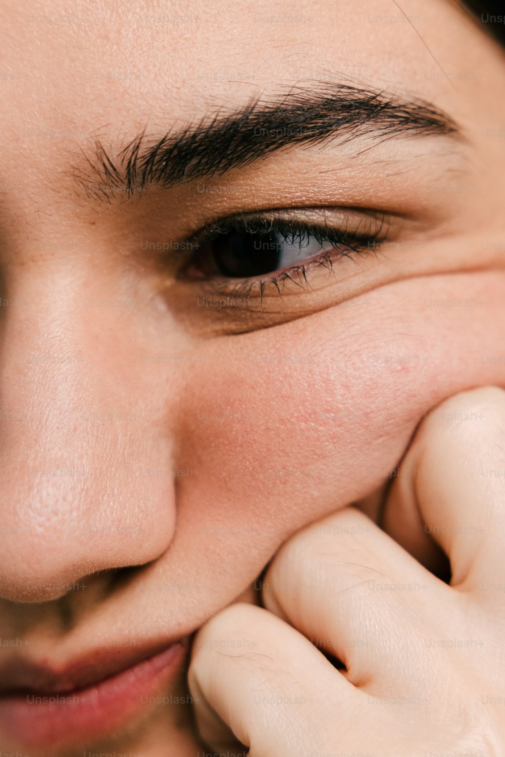 a close up of a person holding a cell phone to their face