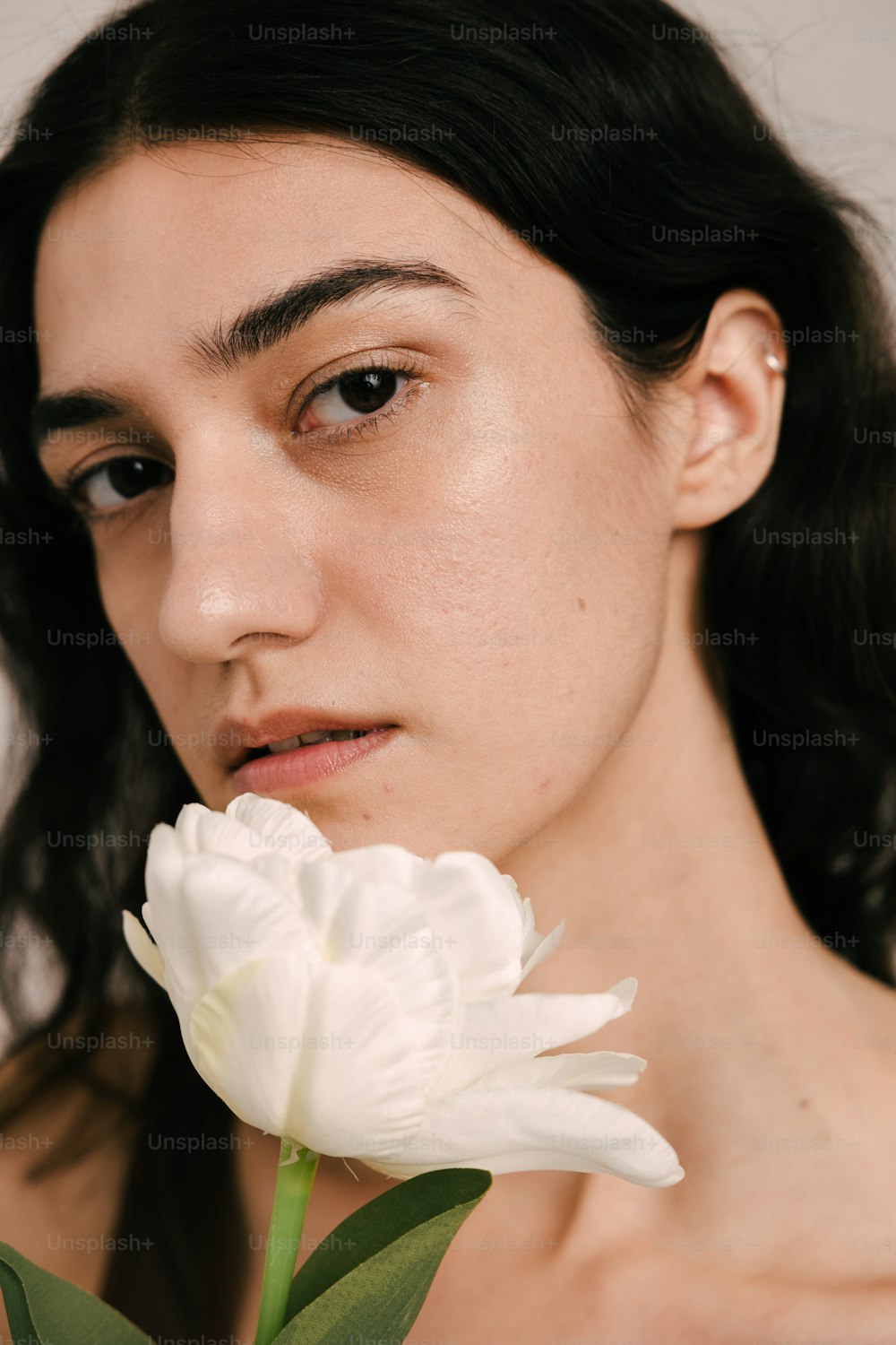 a close up of a person holding a flower