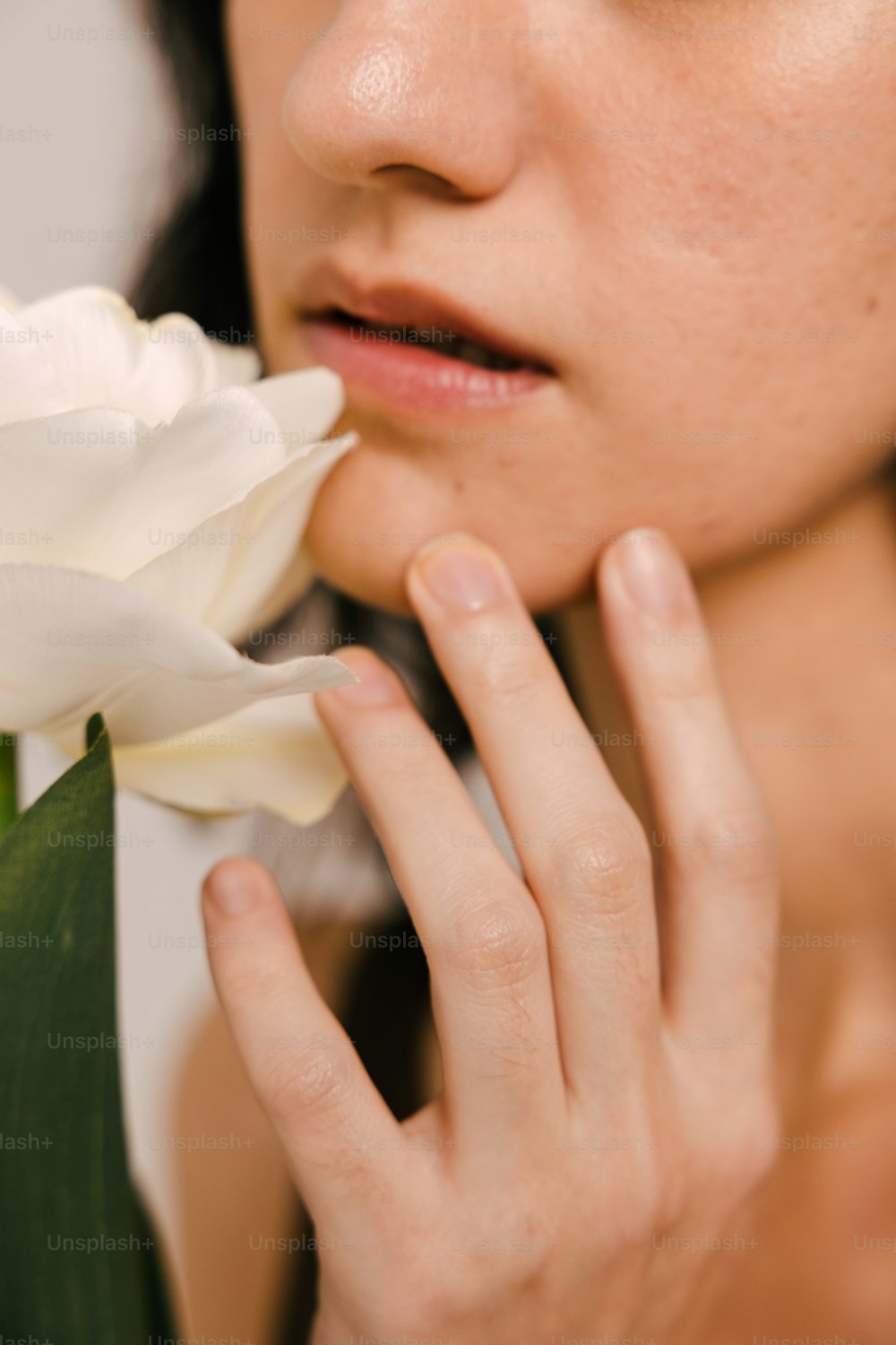 a close up of a person holding a flower