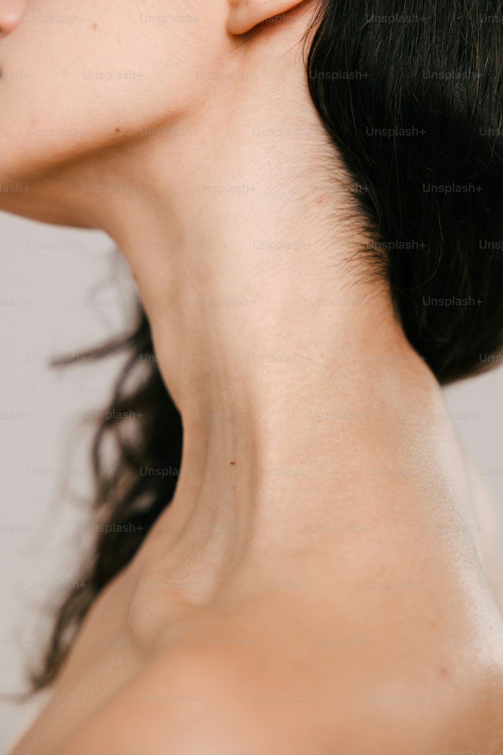 a close up of a woman's neck and ear
