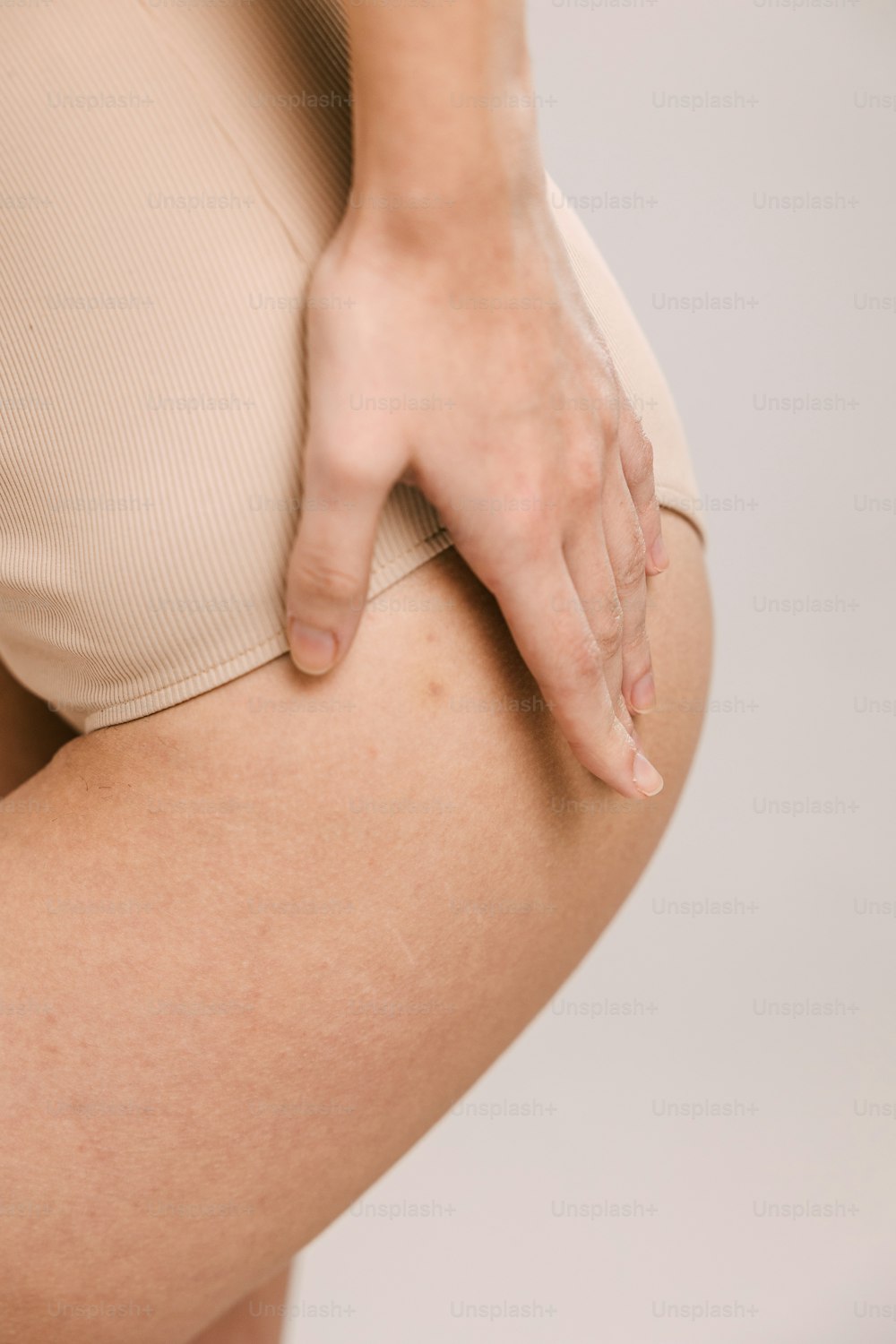 a close up of a woman's butt with her hand on her hip
