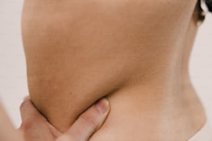 a close up of a person holding their lower back