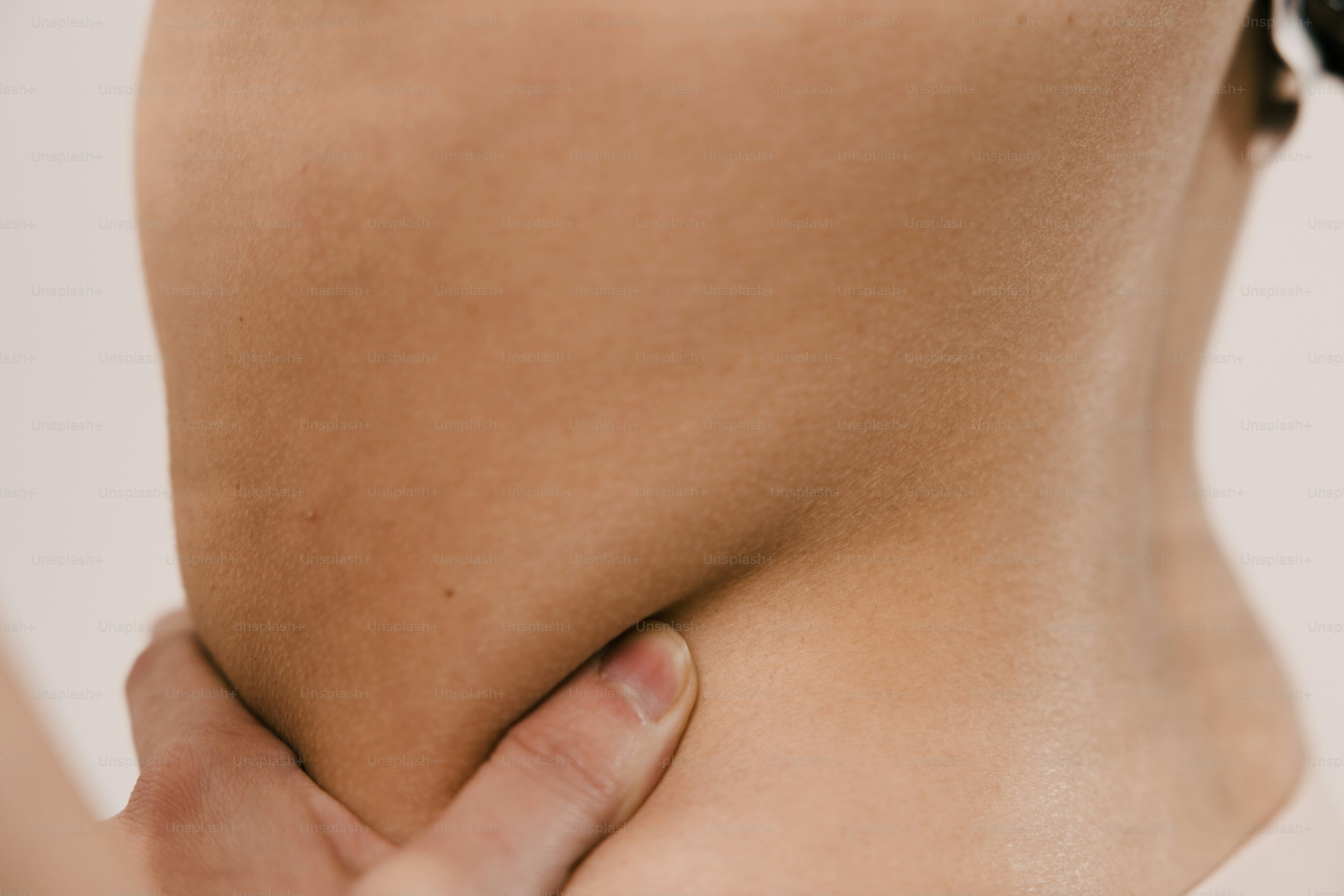 a close up of a person holding their lower back