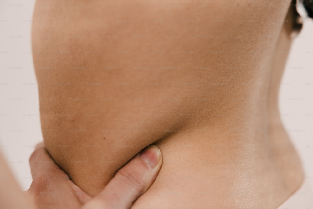 a close up of a person holding their lower back