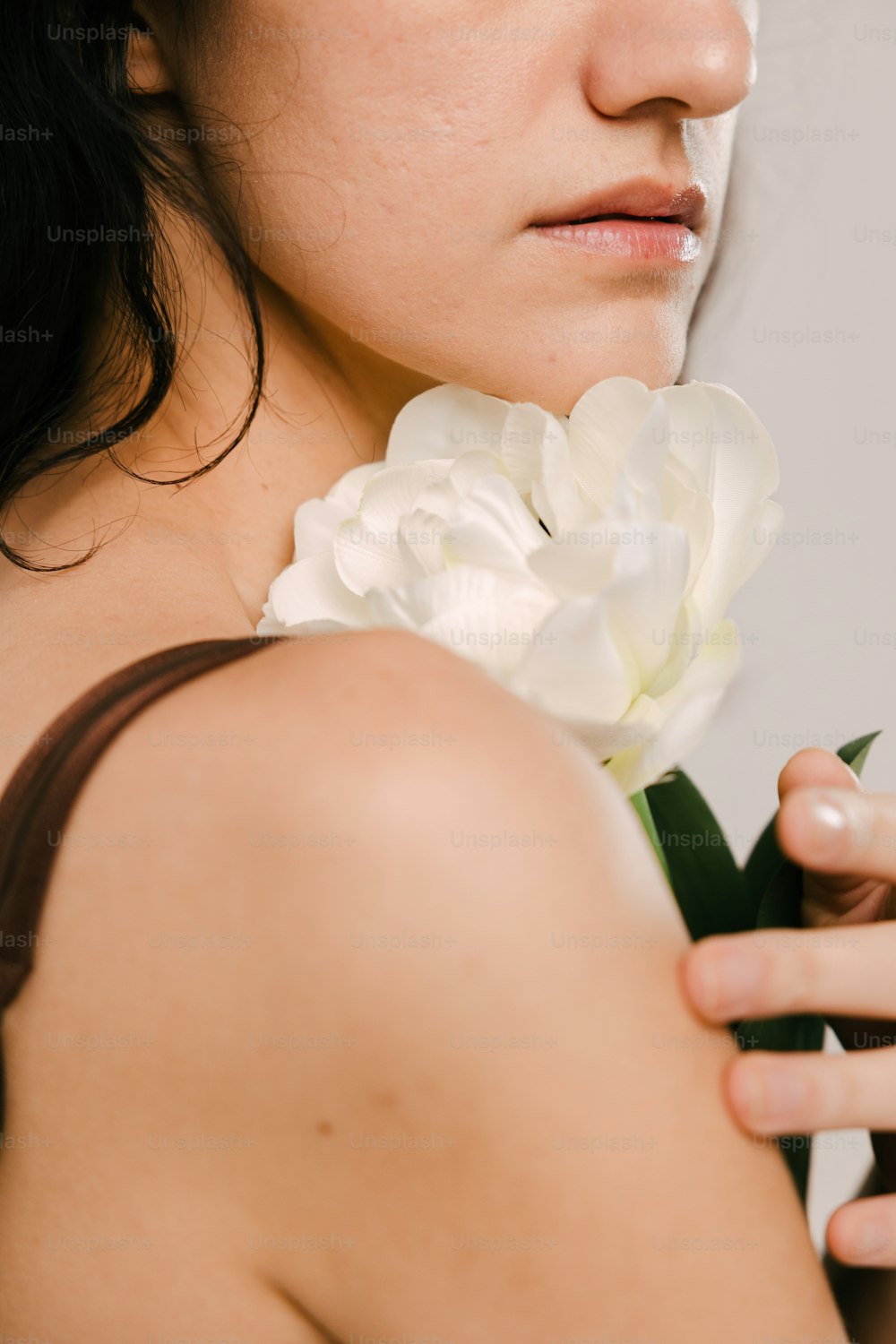 a woman is holding a flower in her hand