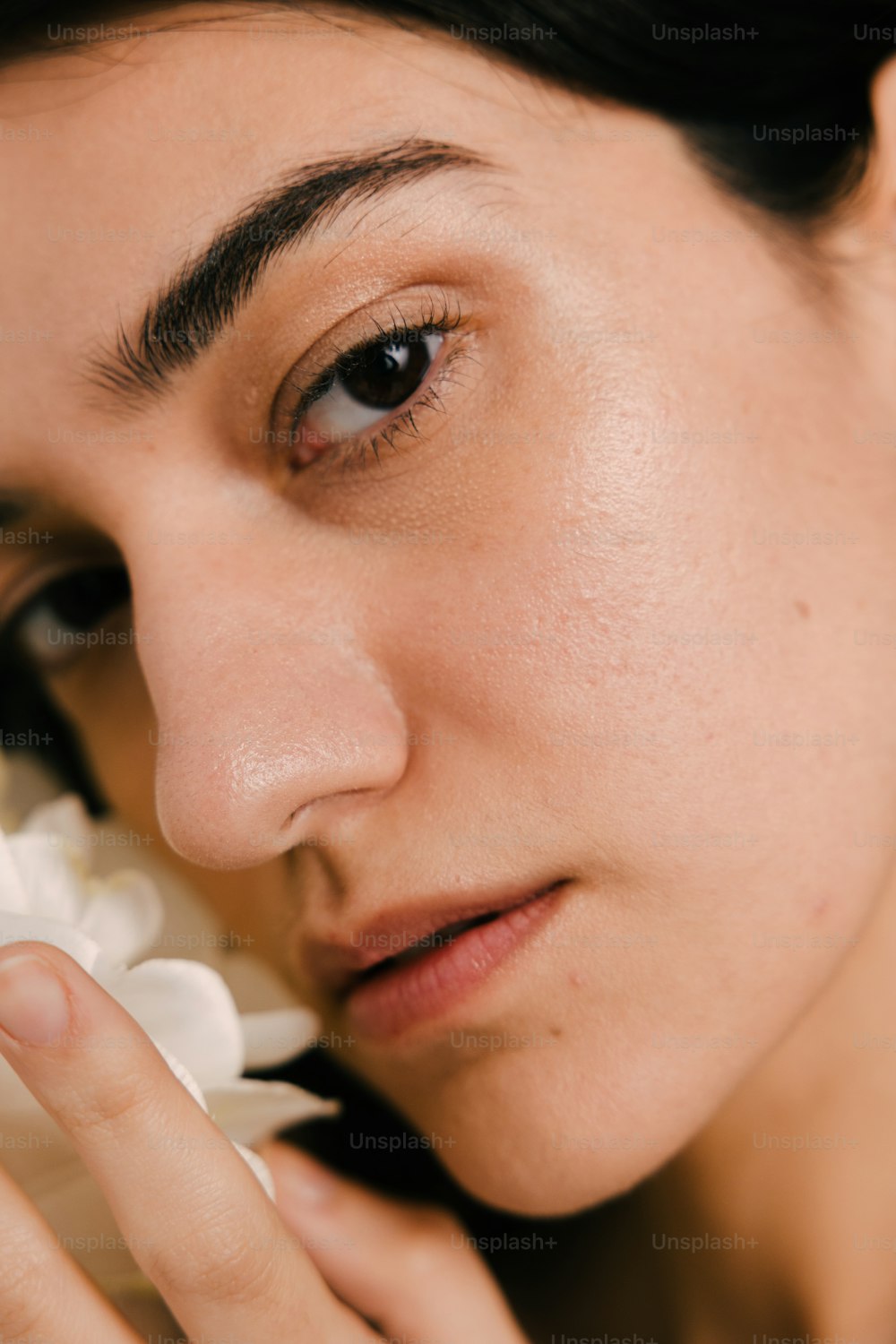 a close up of a person holding a flower