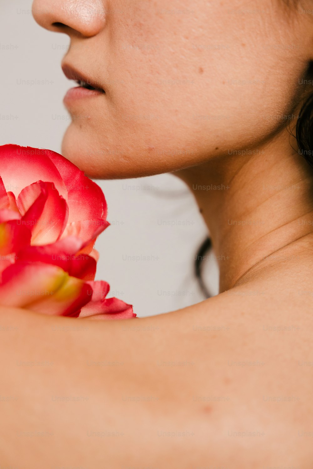 a close up of a woman holding a flower
