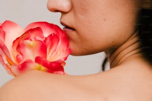 a close up of a person holding a flower