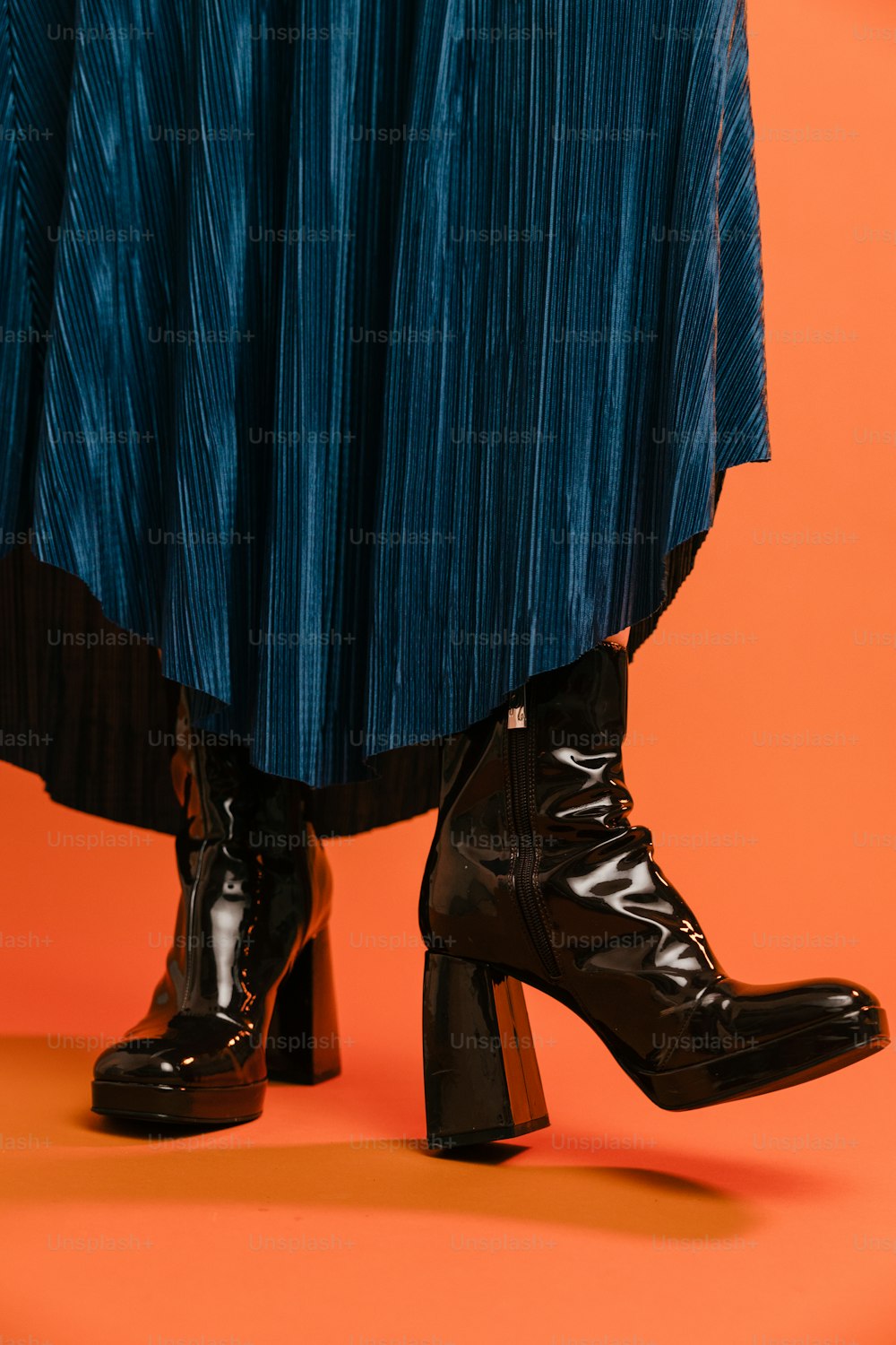 a woman's legs in high heeled black boots