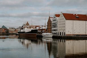 a body of water with a boat and buildings in the background