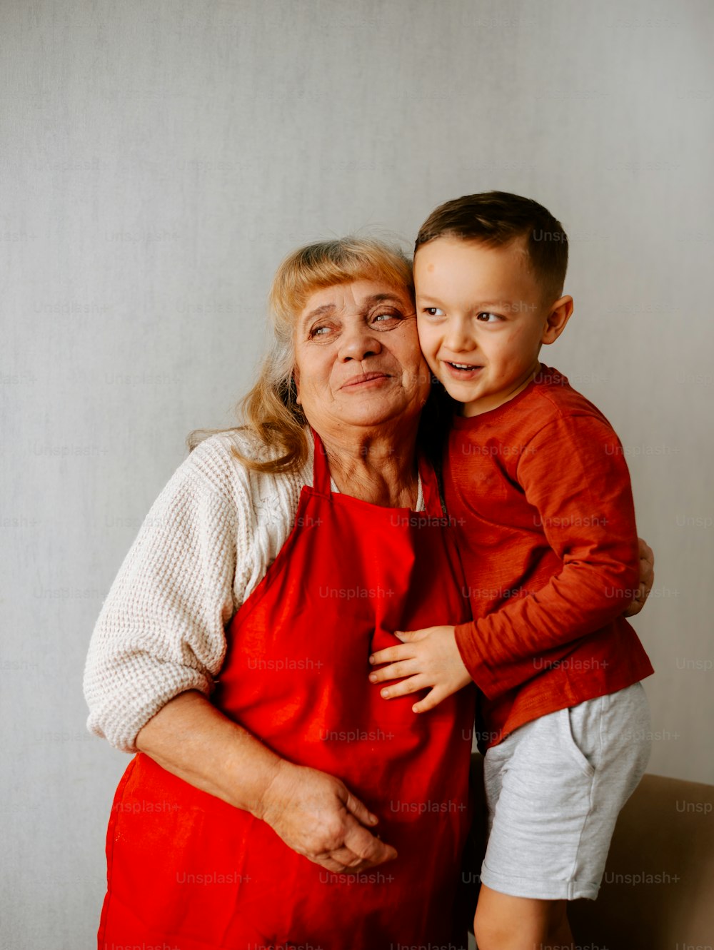 an older woman and a young boy posing for a picture