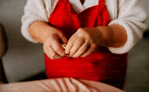 a woman in an apron holding a piece of food