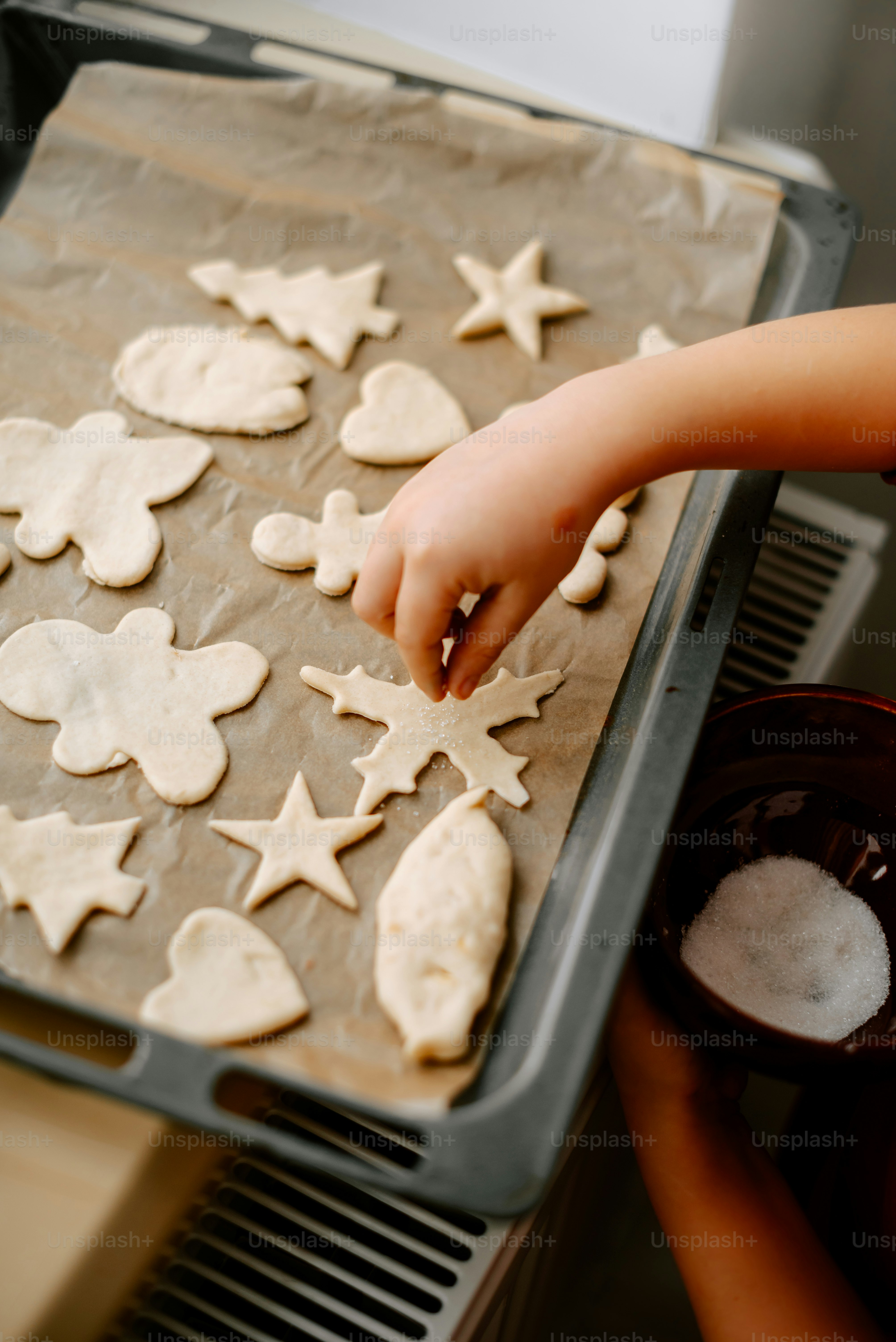 a person making cookies on a baking sheet