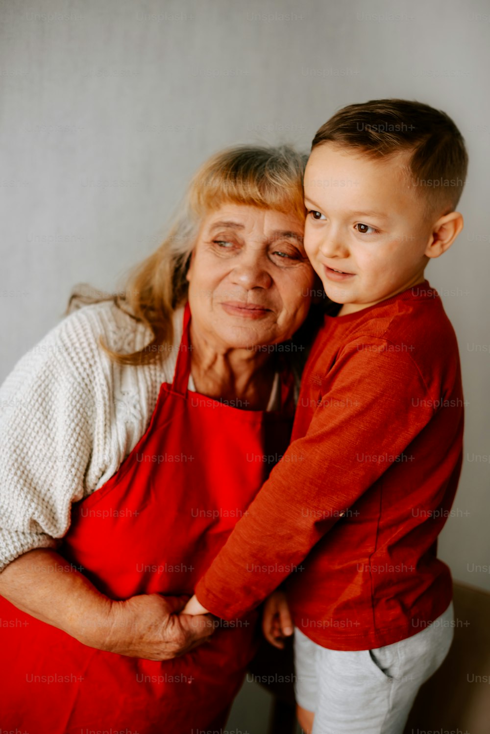 an older woman and a young boy posing for a picture