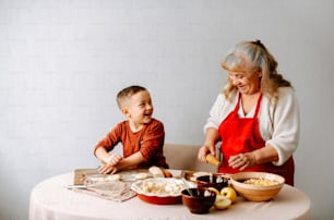 an older woman and a young boy preparing food