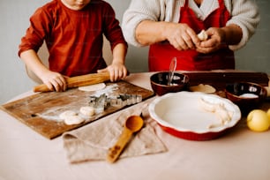 a man and a boy are making food on a table