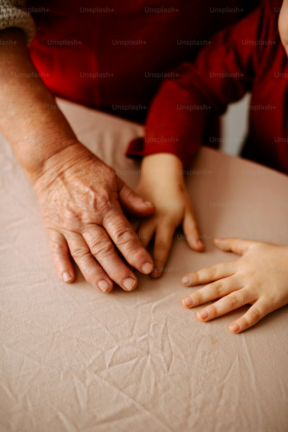 a man and a little girl reaching for something on a table