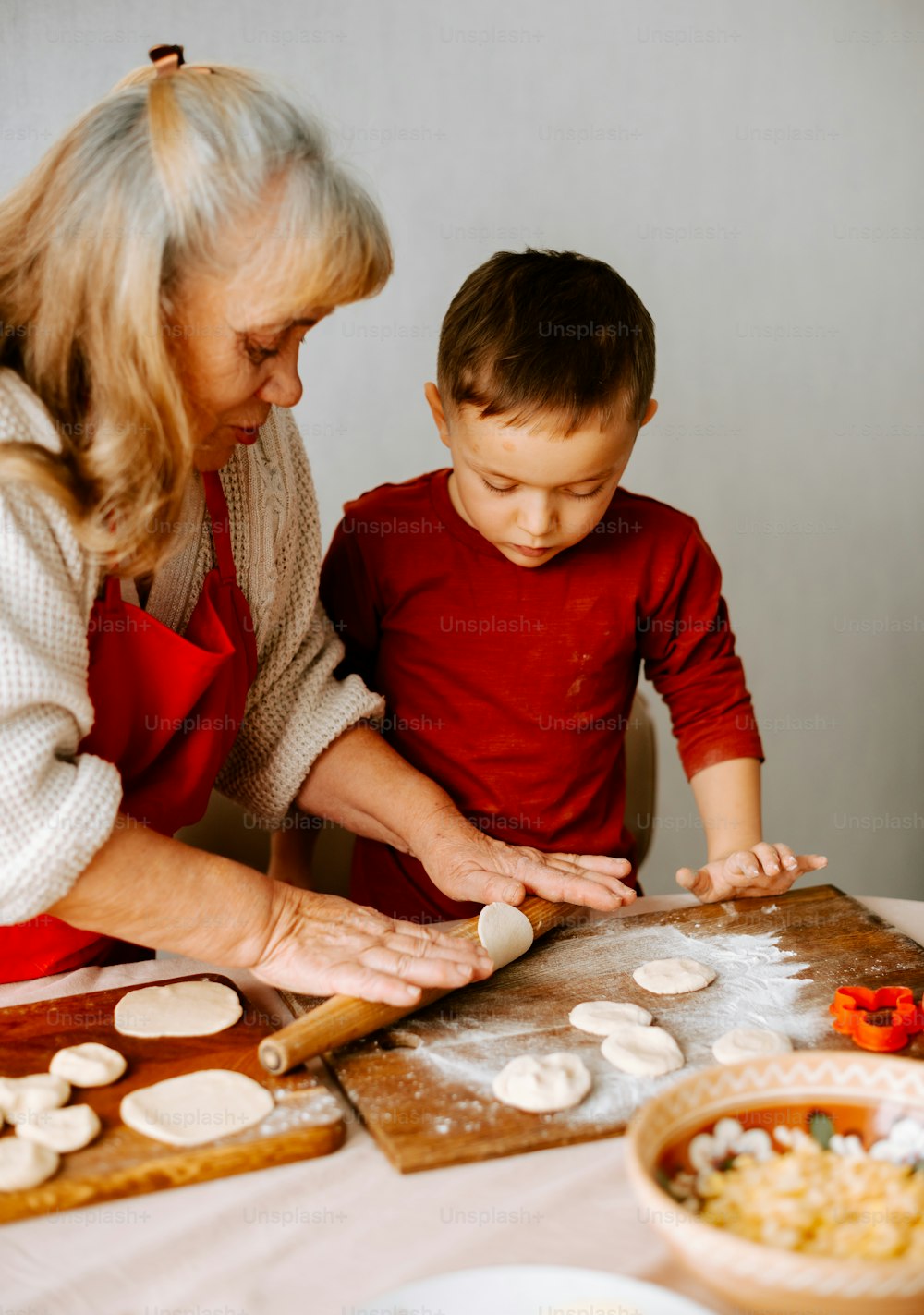 a woman and a child are making cookies