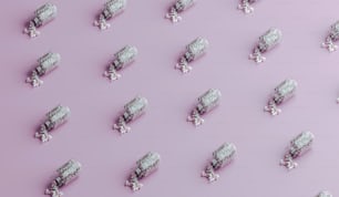 a large group of toy train cars on a pink background