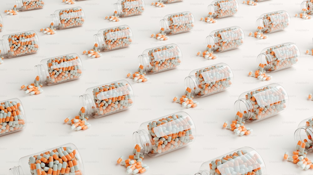 a group of glass jars filled with orange and white pills