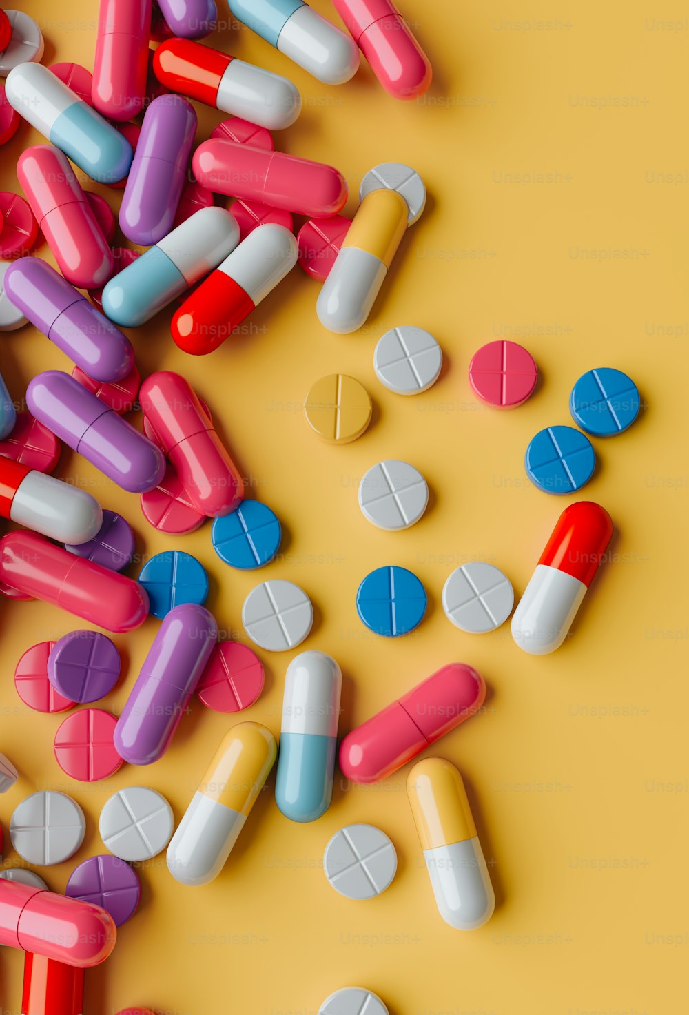 a pile of colorful pills on a yellow background
