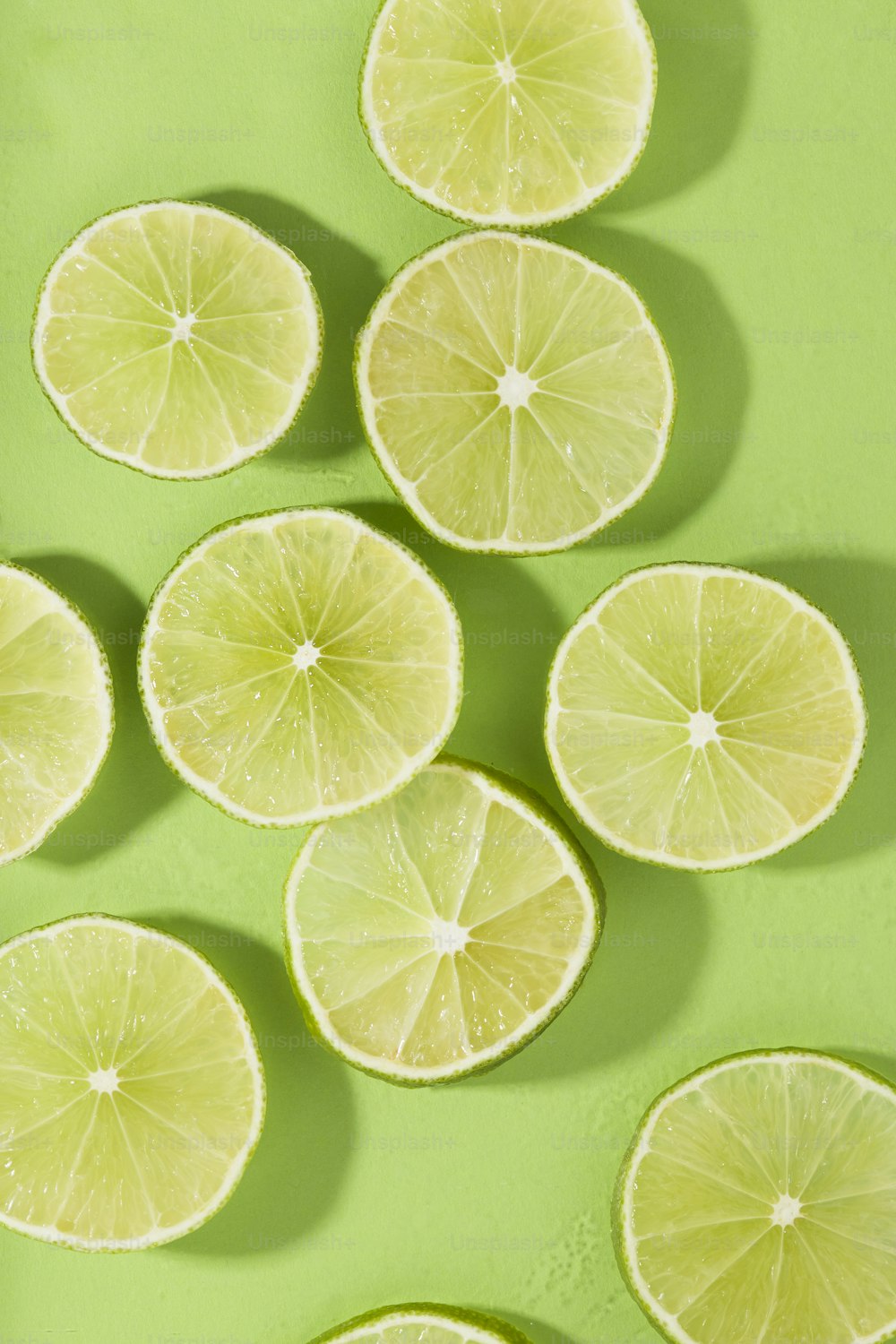 a group of lemons cut in half on a green surface