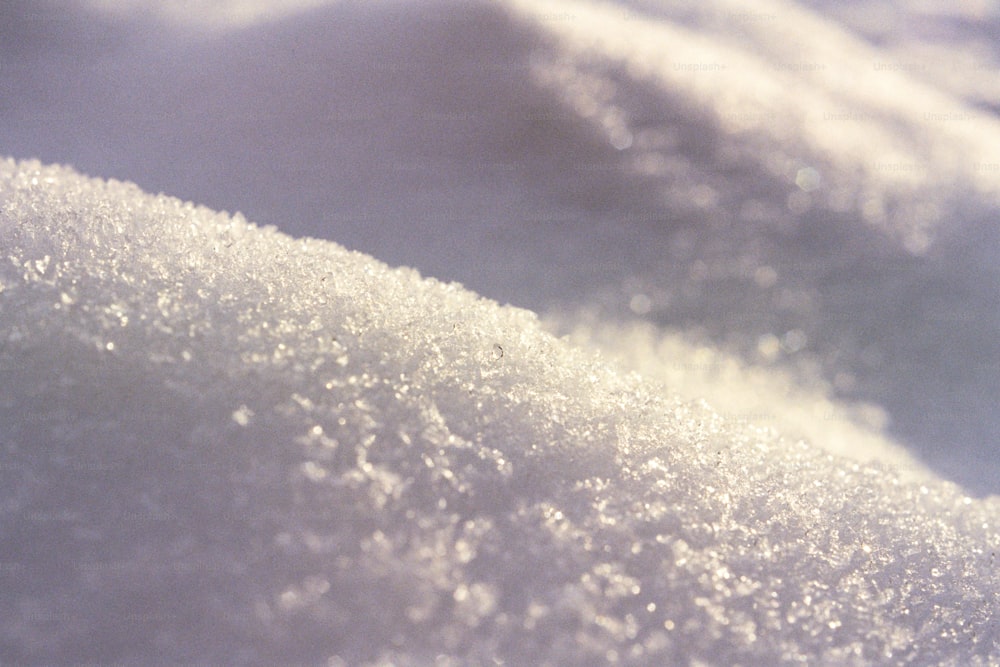 a close up of snow on a sunny day