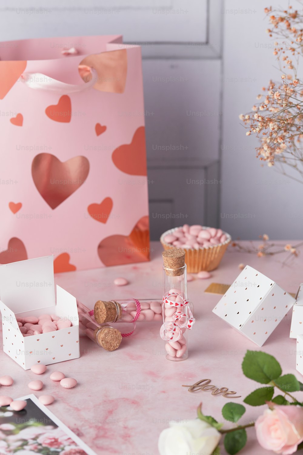 a pink table topped with lots of candy