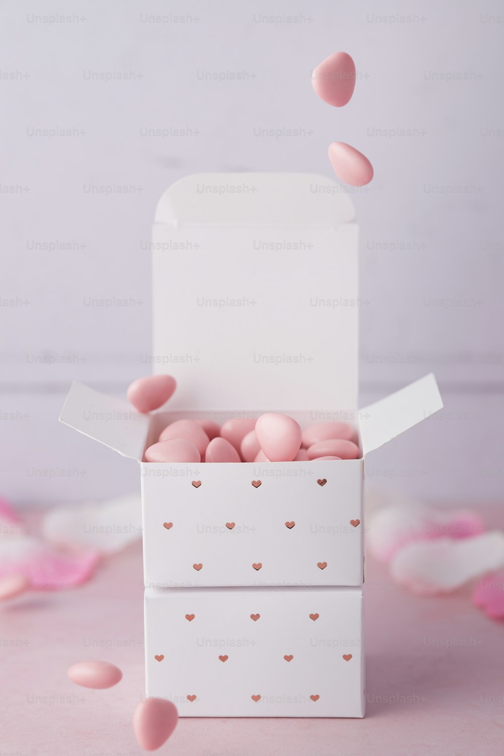 a white box filled with pink hearts on top of a table