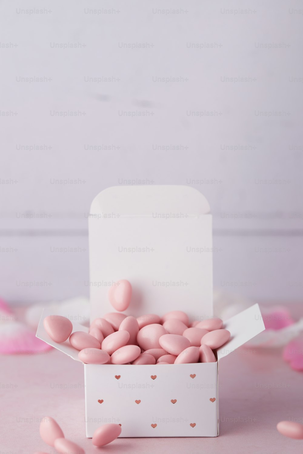 a white box filled with pink candy hearts