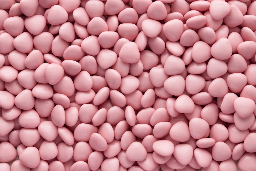 a pile of pink candy pebbles on top of each other