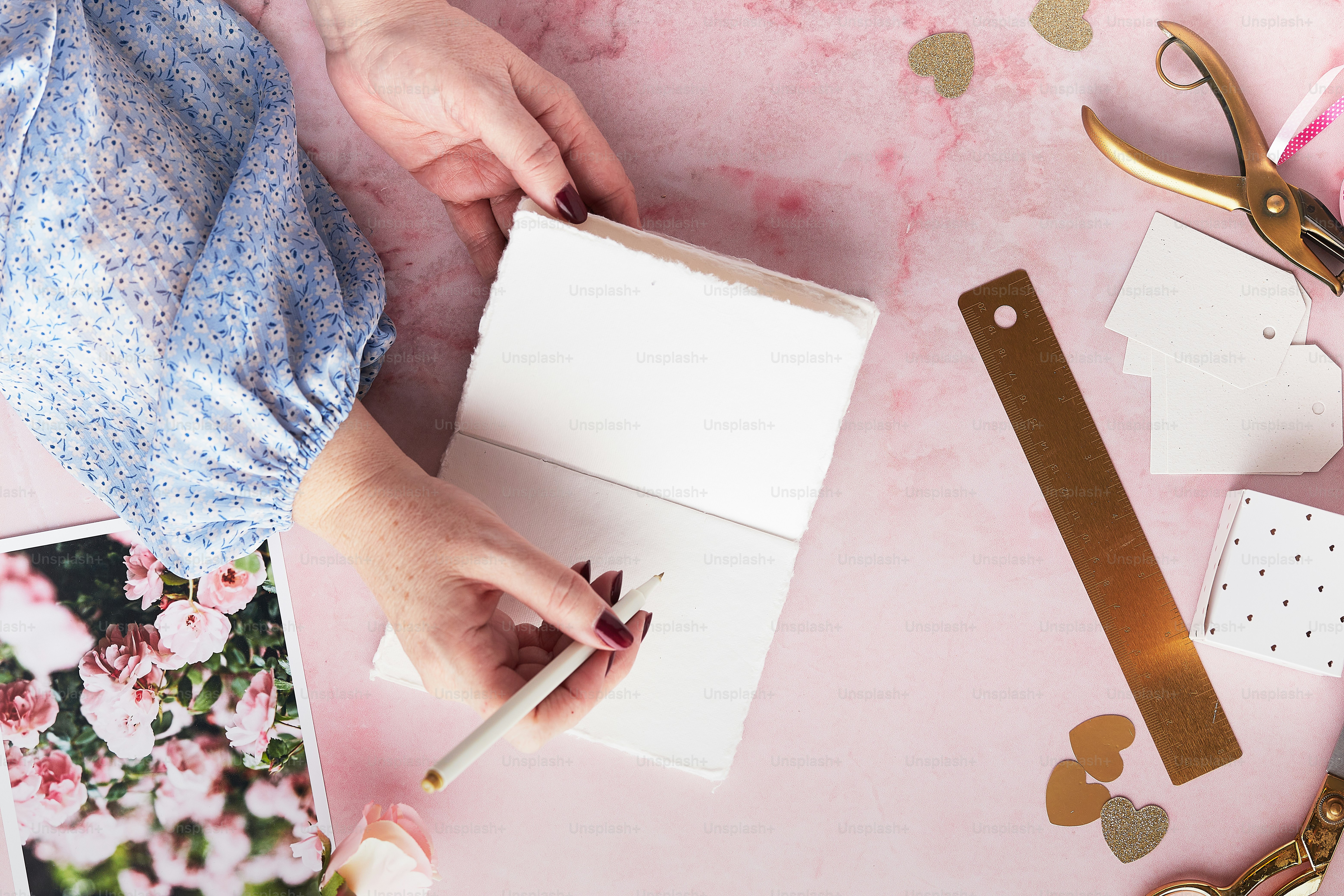 A woman is holding a pencil and a piece of paper photo – Notebook Image ...