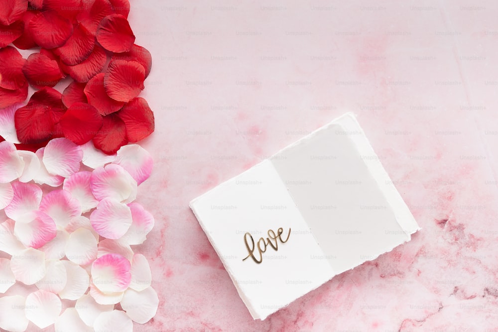 a box of love on a pink marble surface