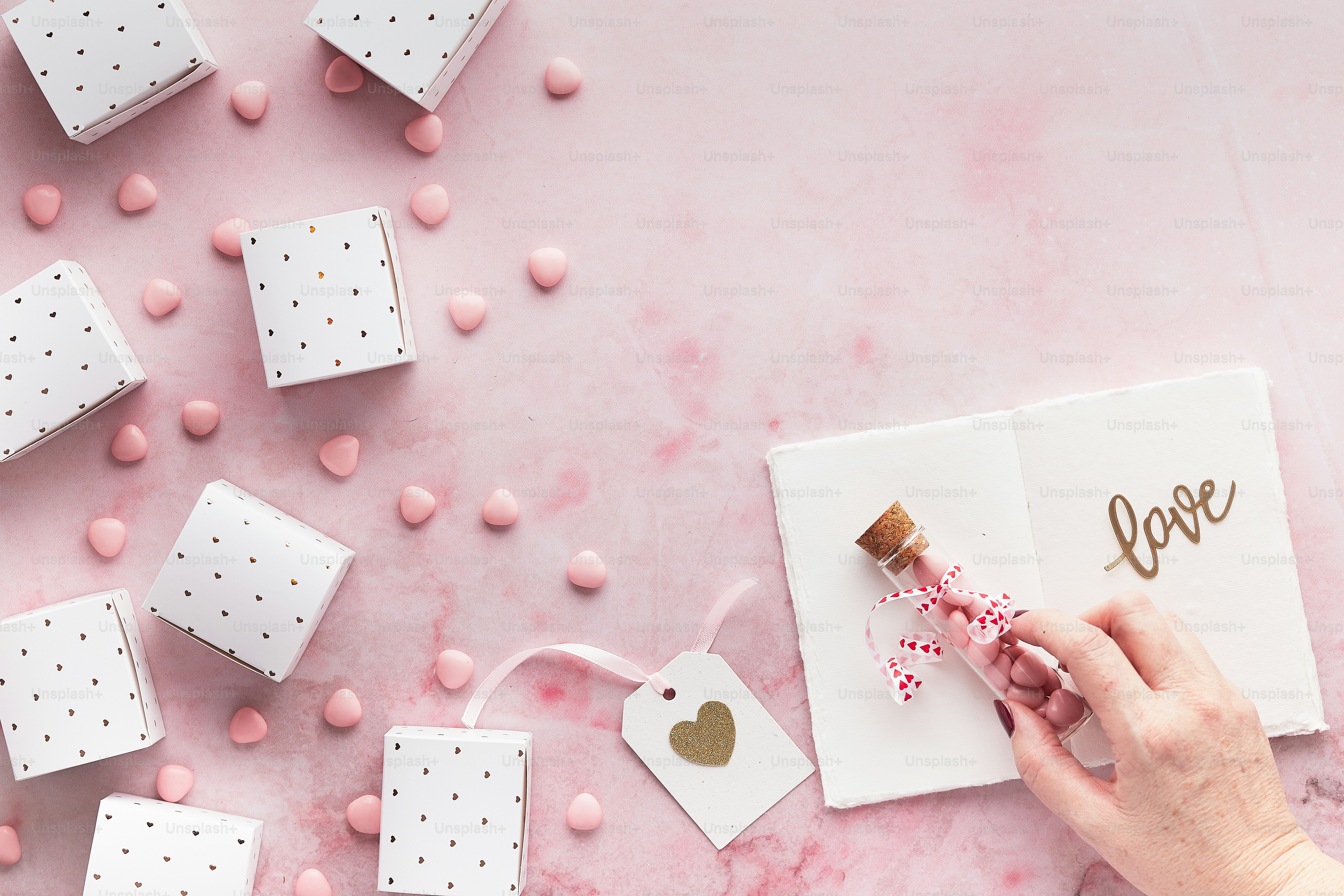 a person holding a piece of paper next to small gift boxes
