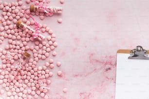a clipboard with pink candy on it next to a clipboard
