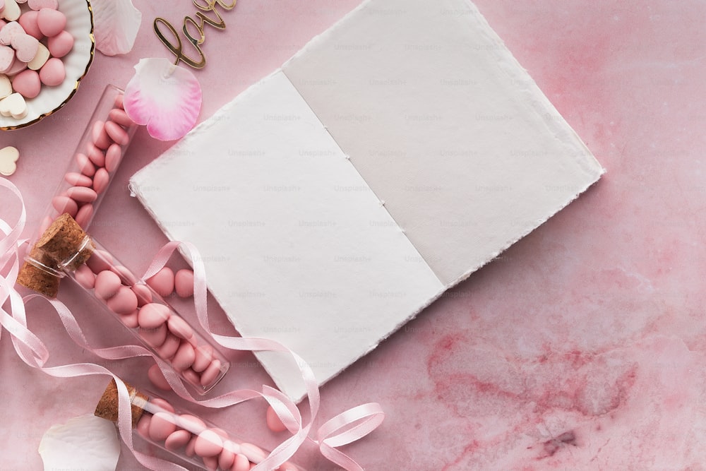 a pink table topped with pink and white candies