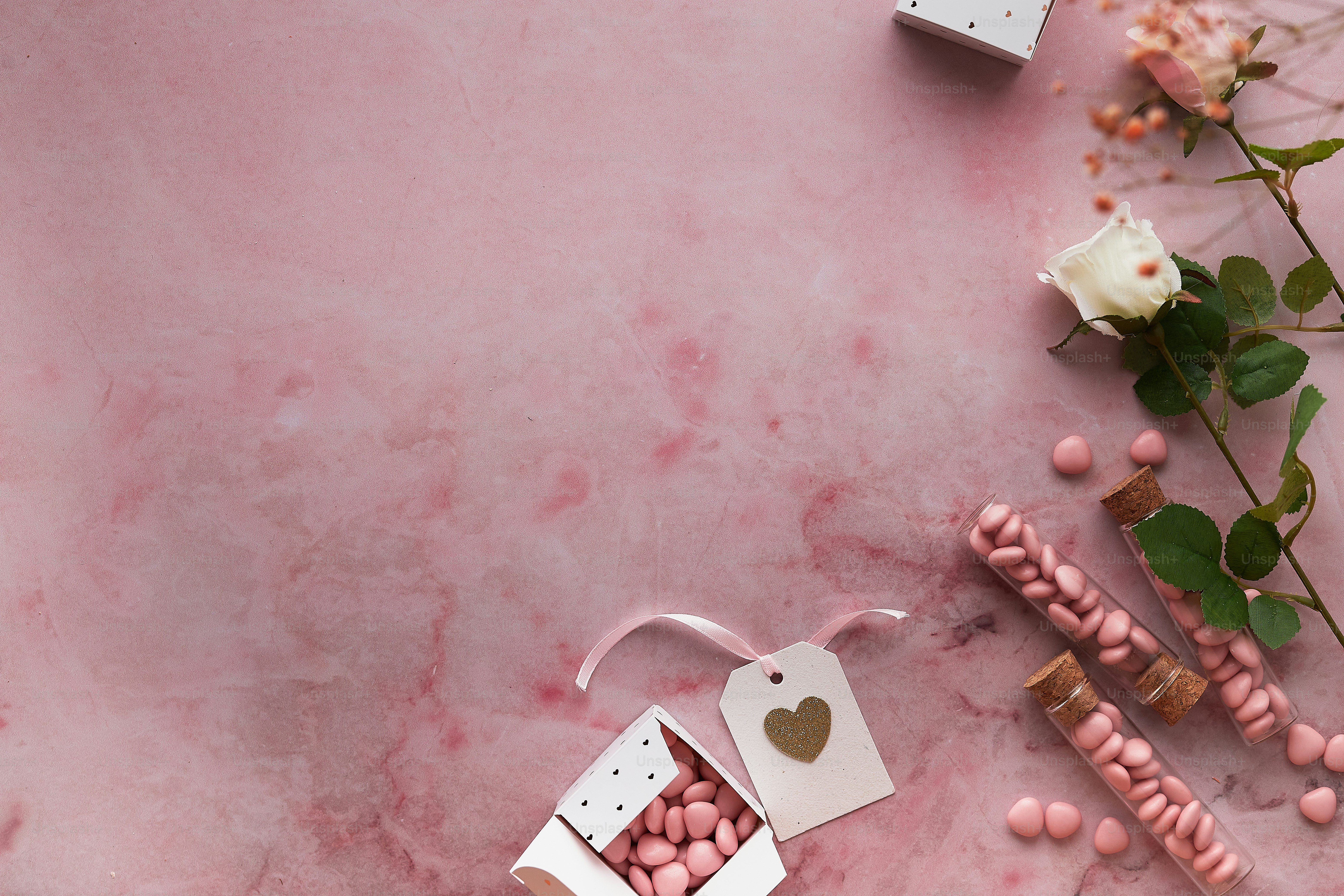 a pink table topped with pink and white candy