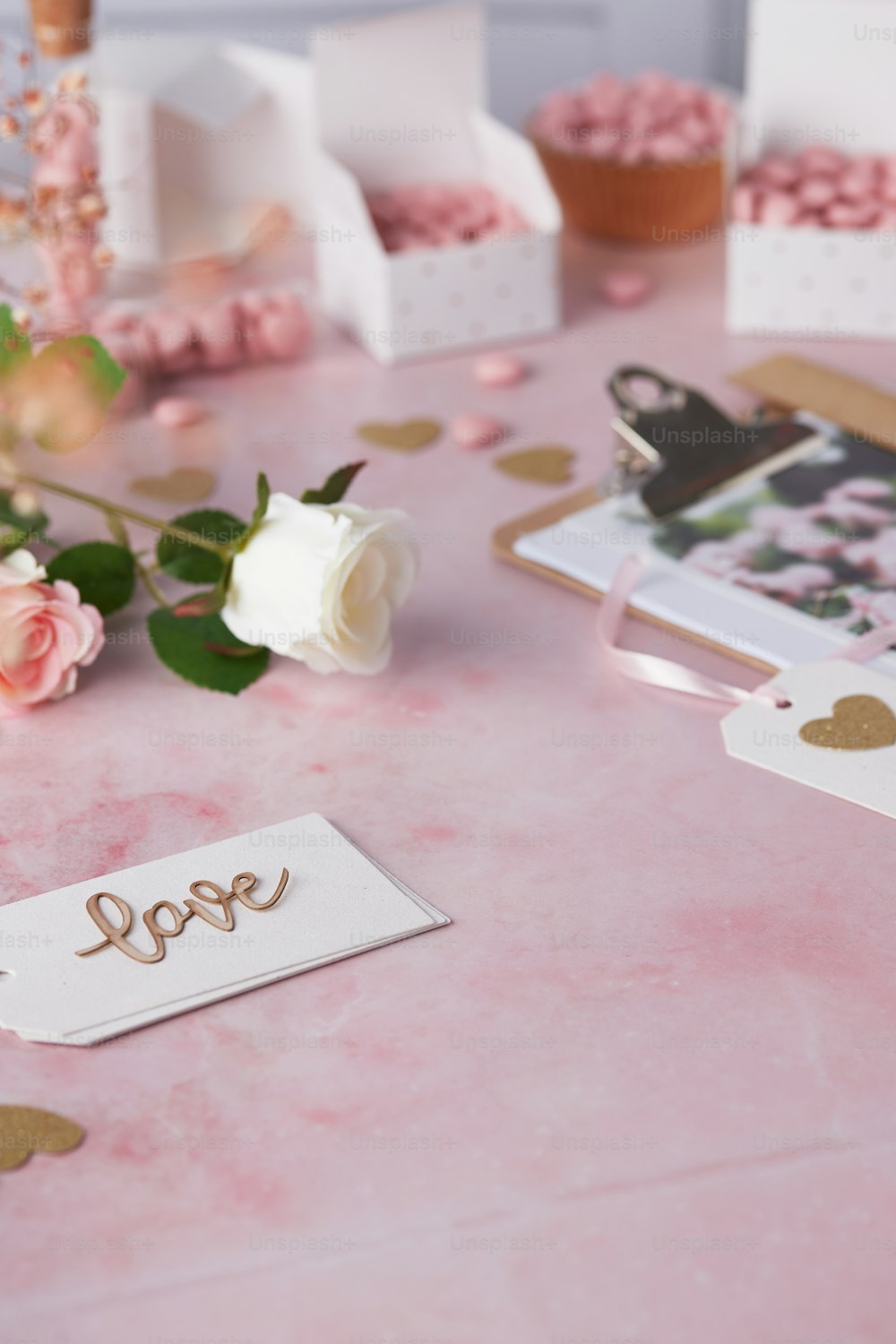 a table topped with pink roses and pictures